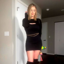 Lizzy, the Stylish Model Posing for the Camera in a Chic Black Dress and Boots