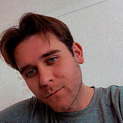 A man from Queensland, Australia with a beard and short hair.