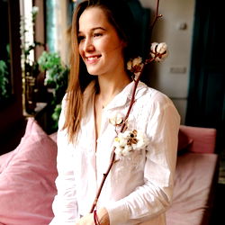 Stylish Woman Posing with a Branch of Flowers