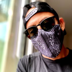 Fashion-forward individual in casual style with bandana and sunglasses