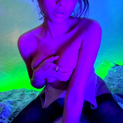 Daisy Rae, a captivating OnlyFans model with striking purple lighting