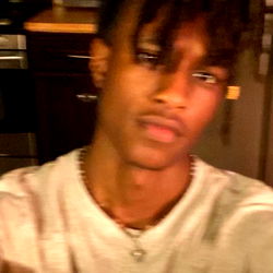 Myron, a young man with dreadlocks and a gold necklace