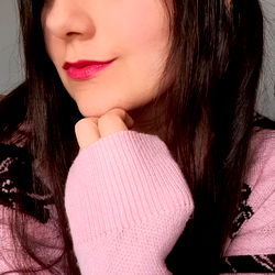 A woman with a nose ring is seen posing for the camera.