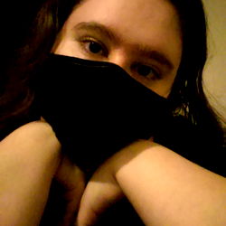 Krissy - A Woman in a Black Mask Resting Her Arm