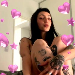 Model pose with a heart-filled backdrop