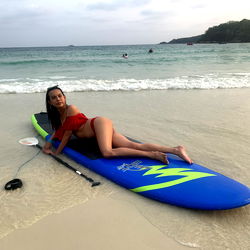 Alice_th, Bangkok Thailand, on a beach with surfboard and yoga mat