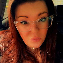 Stylish Woman with Glasses and Red Hair