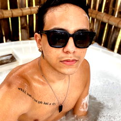 Young, Tattooed Man in Swimming Pool