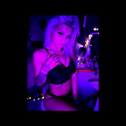 Abs, the Instagram model in a pink bra, striking an intense pose