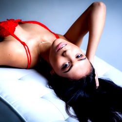 Anastasia, an OnlyFans model from Melbourne, in a seductive pose on a chair.