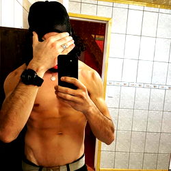 Shirtless Fitness Model Taking a Selfie in the Mirror