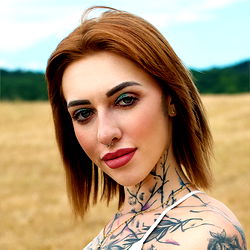 Venom Vixen, Onlyfans Model with Tattoos and Short Hair