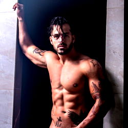 Fit Model Adriel Fernandes Leaning on Wall