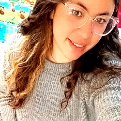 Smiling Woman with Glasses and Blonde Hair in a Blue Sweater