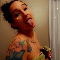 PrettyMomma87 in a bathroom, playfully sticking out tongue
