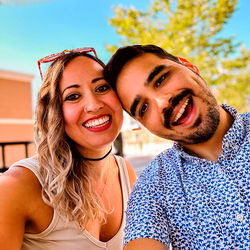 Jess and Chris, a happy couple sharing a selfie moment in their hometown