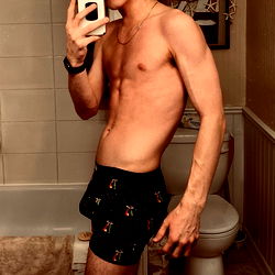 John, a 25-year-old model posing in his bathroom.