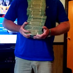 A Man Displaying a Collection of Bills