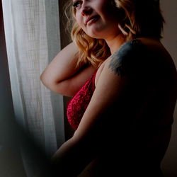 Mak, a young adult female model poses by the window