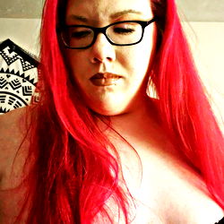 Red-haired woman in black lingerie and glasses