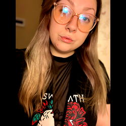 Woman in Oversized Glasses with Piercings and Nose Ring