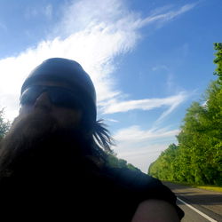 Bearded Biker Riding on Road