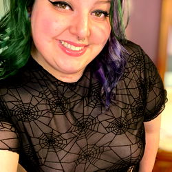Smiling Woman in Vampire Fashion Shirt, with Spiderweb Design and Purple Hair