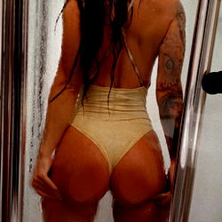 Bikini-clad model in bathroom shower, onlyfans