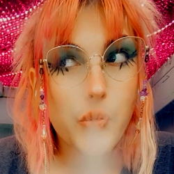 Succulent Fox: Pink Haired Musician with Vintage Glasses and Flowing Earrings