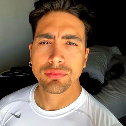 Fitness model Andres Cardenas in outdoor athletic attire,