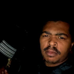 A mysterious masked figure in a dimly lit room