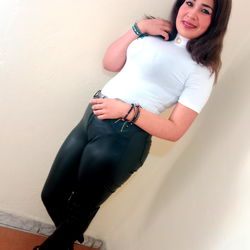 Model in a White T-Shirt and Leather Jeans Posing with Confidence