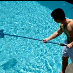 Fitness Model Posing with Pool Cleaner