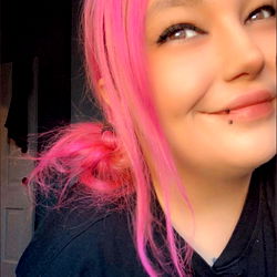 Trendy Pink Haired Woman in a Black Jacket with Ponytails, Smiling and Looking into the Camera