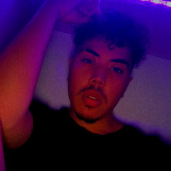 Akeim Takamura - Striking a pose in front of the camera with neon lights as a backdrop