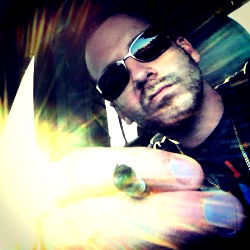 A Man with Sunglasses Holding a Cigarette