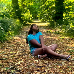 A Woman Relaxing in a Forested Path