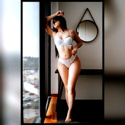 Model Sofía in Lingerie, Cityscape Backdrop