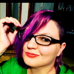Violet-haired woman with short hair and glasses