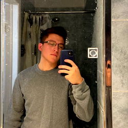 Young Man in Grey T-Shirt, Taking a Selfie with Blue Phone