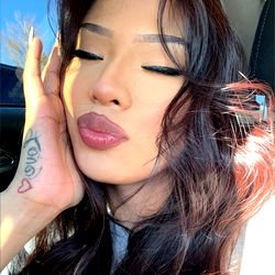 Stylish Selfie of an OnlyFans Model with Strong Eyes and Long Hair