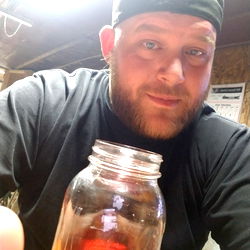 Man with beard in front of mason jar