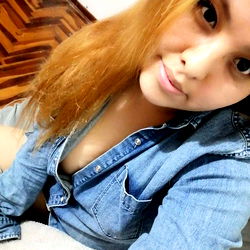 Alis, a young adult female posing in a blue jean shirt and glasses