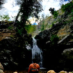 Sass Queen in an Enchanting Forest Setting, Admiring a Waterfall