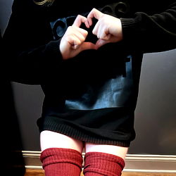 Trendy Female Model Posing with Hands Forming a Heart