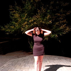 Stylish Model Showcases Spring Outfit Against Backdrop of Brick Courtyard