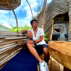A man posing on a rooftop patio