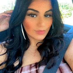 Abi on OnlyFans, posing in a car