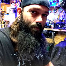 Bearded Man with Tattoos in a Workshop