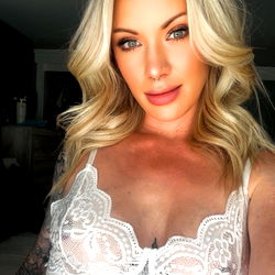 Glamorous model showcasing lingerie in a room with decorative ceiling fan,